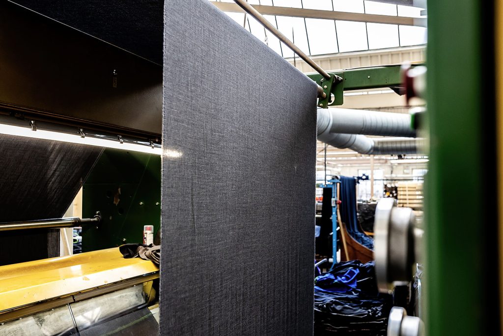 Grey cloth draped over the edge of a cropping machine