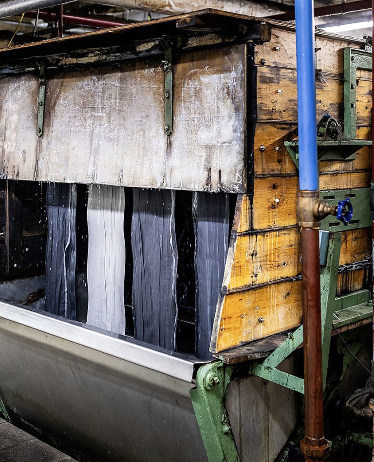 Navy wool cloth ropes running through the wooden scouring trough