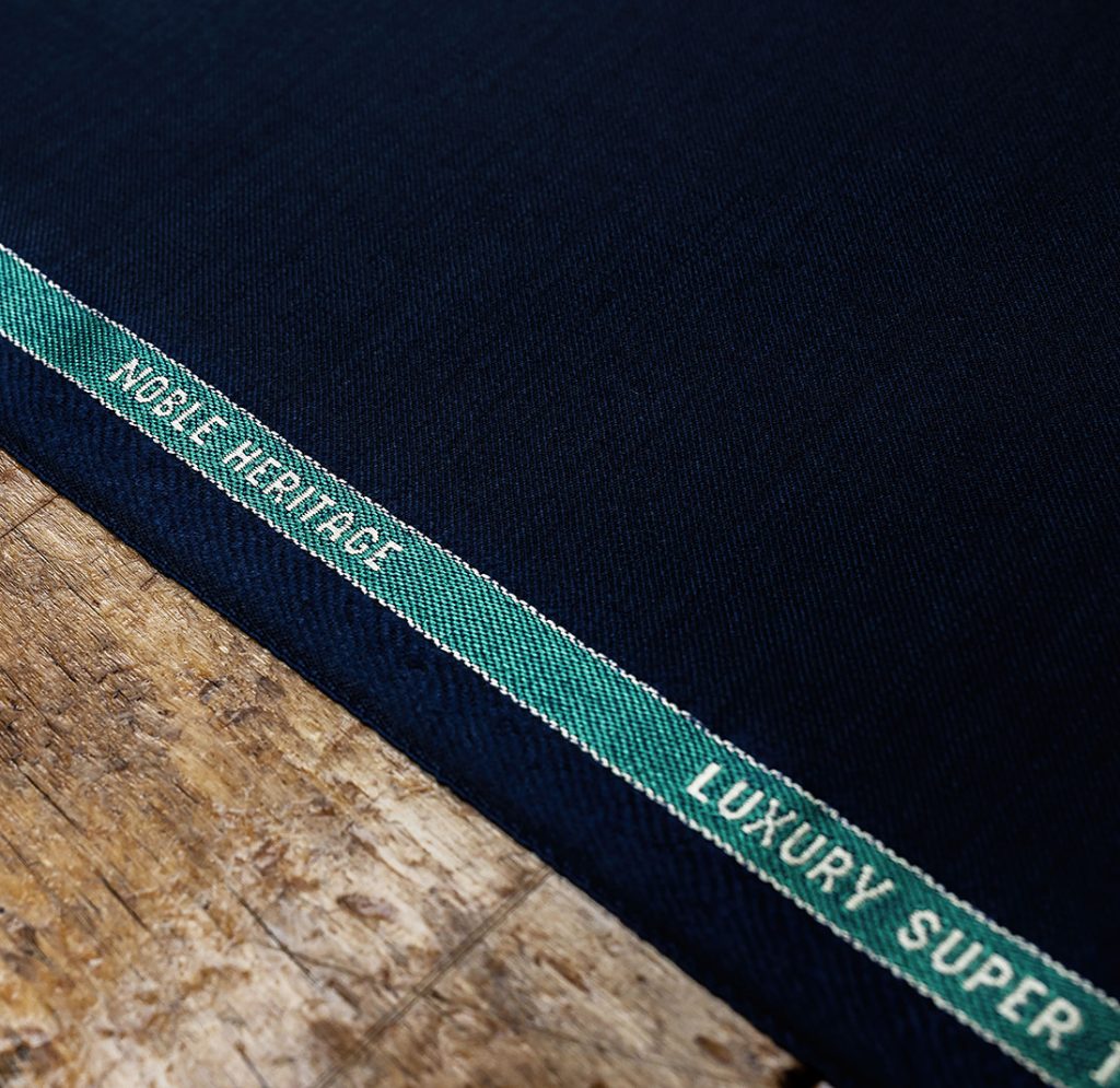 Close-up of navy cloth woven with 'Noble Heritage' lettering